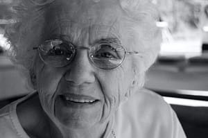 Close-up of an elderly woman wearing glasses.