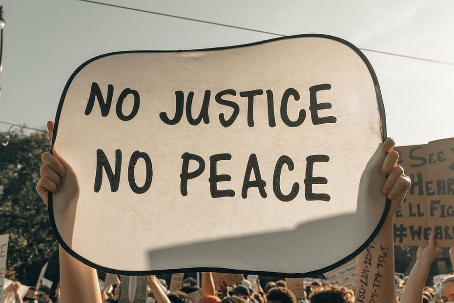 Protestor sign that reads, "No Justice, No Peace"